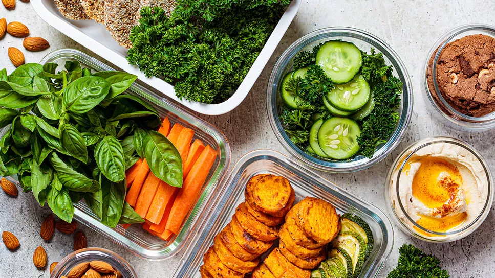 Organized meal containers with balanced portions of vegetables, grains, and proteins